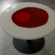 Tavolo tondo diametro 120 cm. Struttura in ferro e piano d'appoggio in resina trasparente e colorata a strati.